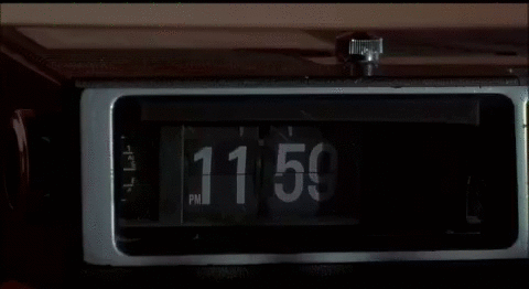 Digital clock showing 11:50 in dim lighting