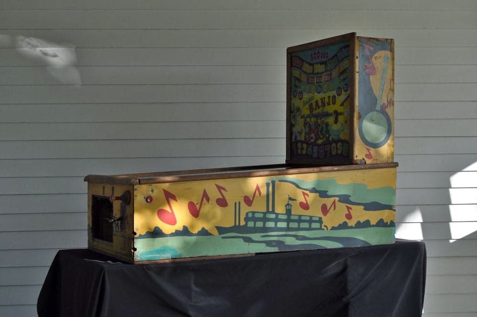 Vintage musical box with factory scene and musical notes on yellow background