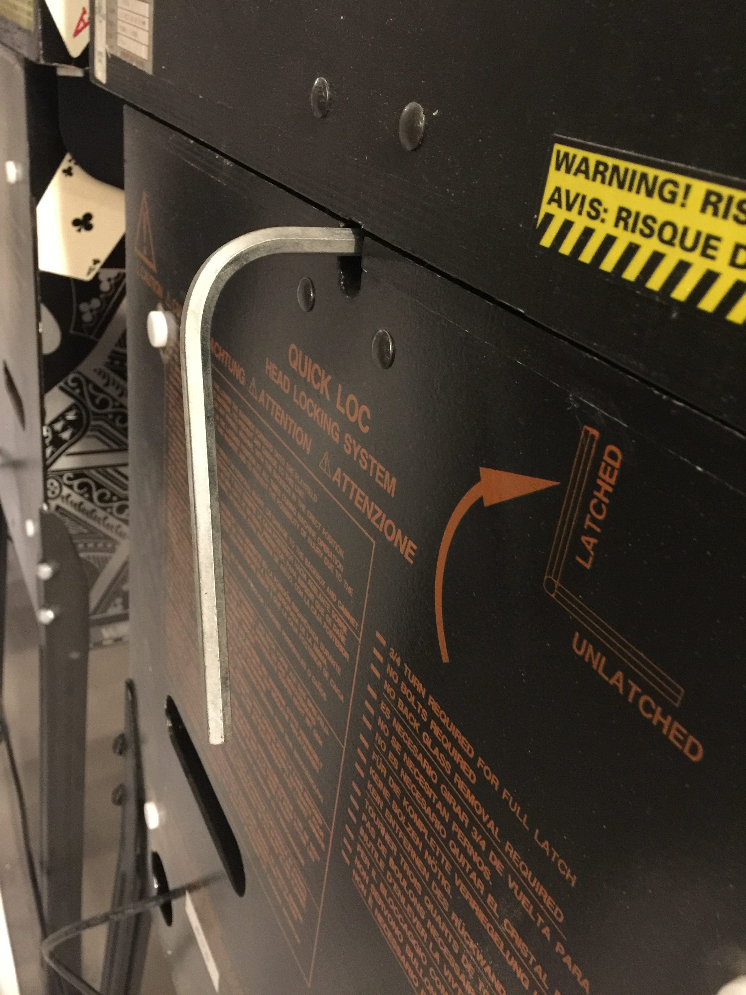 Warning label on industrial equipment with quick lock system and safety instructions