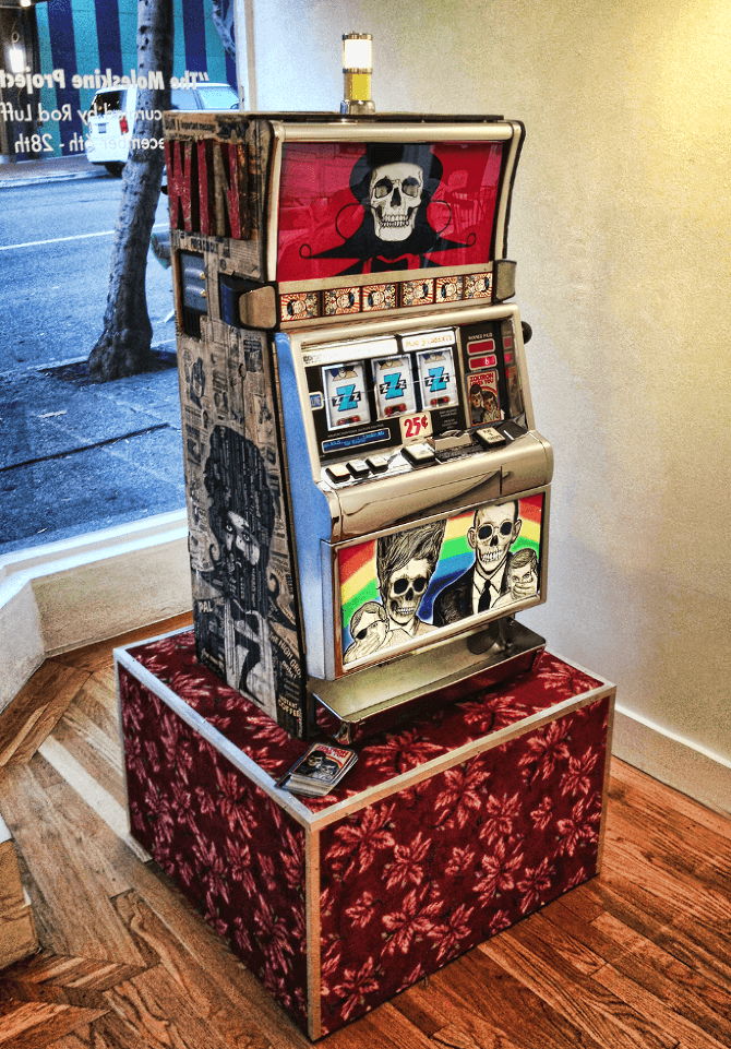 Vintage slot machine with skull graphics on red patterned display stand