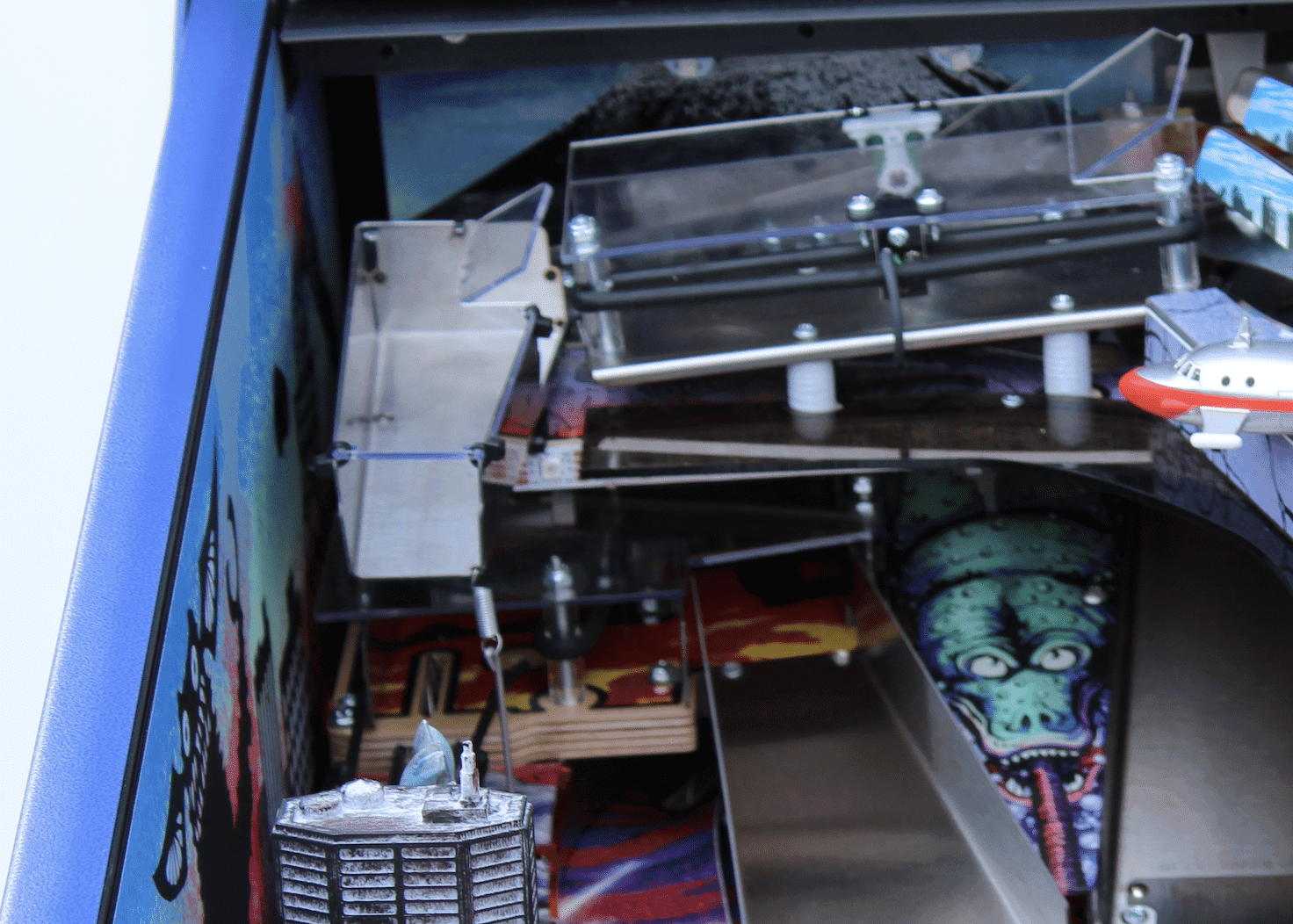 Intricate machinery with metallic components and a creepy alien graphic