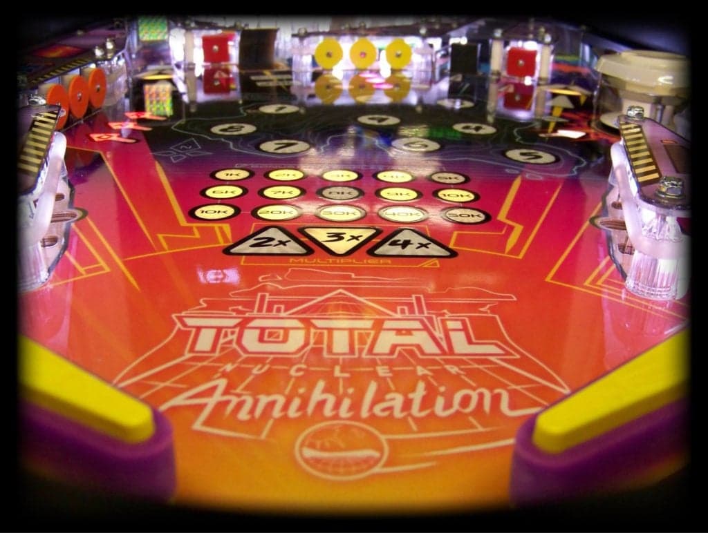 Total Annihilation pinball machine with colorful playfield and yellow buttons